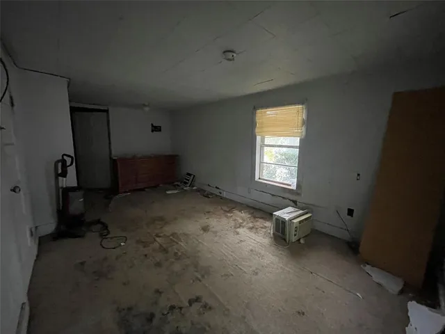 a room with exposed radiator and window