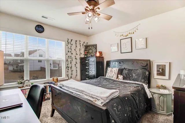 a white bath tub sitting in a bathroom next to a window