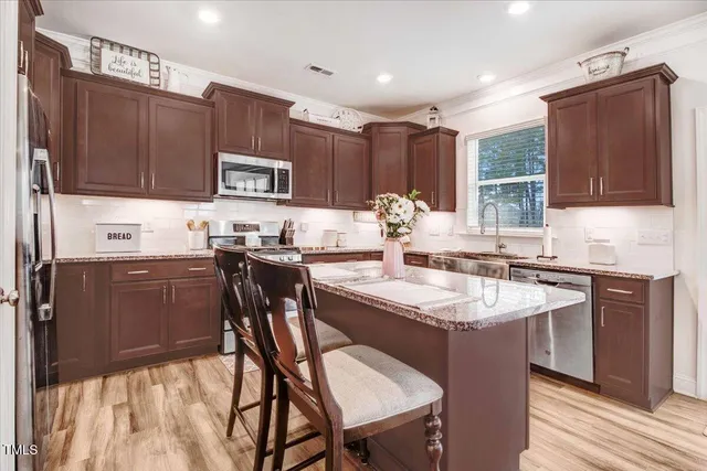 a kitchen with a sink stove and cabinets