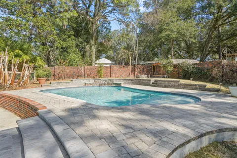 a view of a porch with furniture and garden