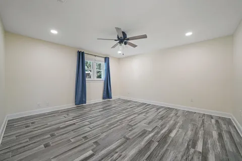 a spacious bathroom with a granite countertop sink a mirror and a shower