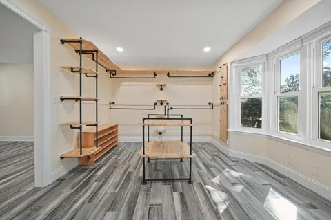 a view of a room with furniture window and wooden floor