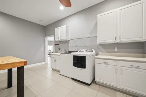an empty room with wooden floor and ceiling fan