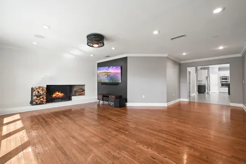 a view of an empty room with a fireplace and a window