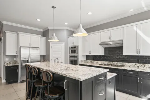 a kitchen with a stove a sink and microwave