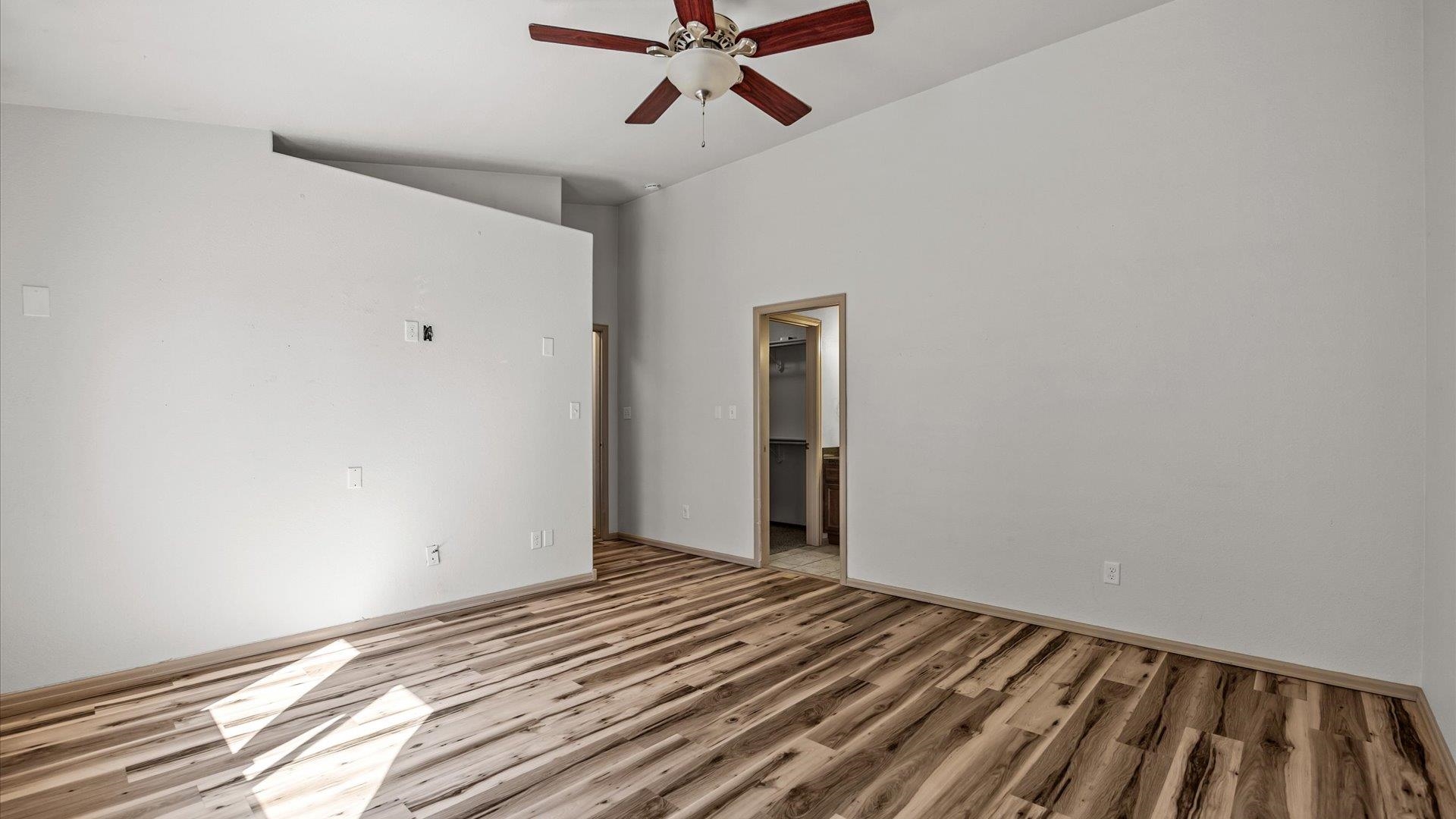 596 Sinatra Way Grand Junction, CO 81501 - Photo 13 of 20 a view of a room with wooden floor and a ceiling fan