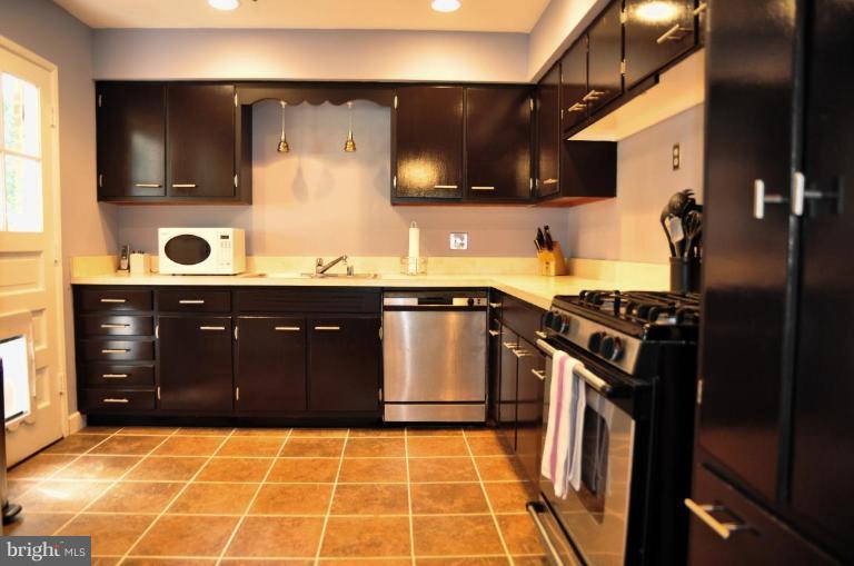 5229 Inverchapel Road Springfield, VA 22151 - Photo 19 of 27 a kitchen with a sink a stove and cabinets