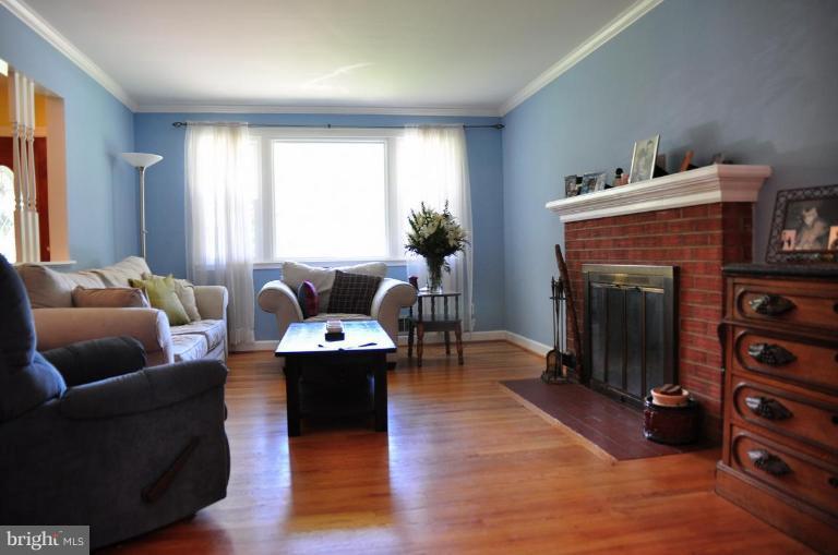 5229 Inverchapel Road Springfield, VA 22151 - Photo 4 of 27 a living room with furniture and a fireplace