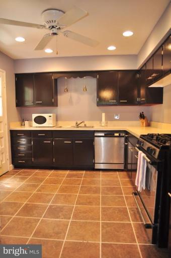 5229 Inverchapel Road Springfield, VA 22151 - Photo 7 of 27 a large kitchen with granite countertop a sink and a stove