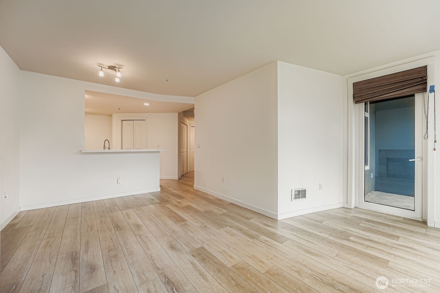 2607 Western Avenue, Unit 612 Seattle, WA 98121 - Photo 12 of 29 a view of empty room with wooden floor and cabinet