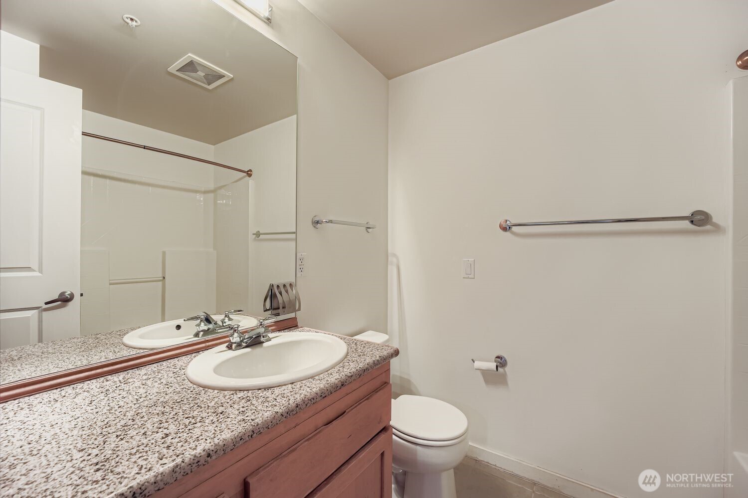 2607 Western Avenue, Unit 612 Seattle, WA 98121 - Photo 18 of 29 a bathroom with a granite countertop sink and a mirror