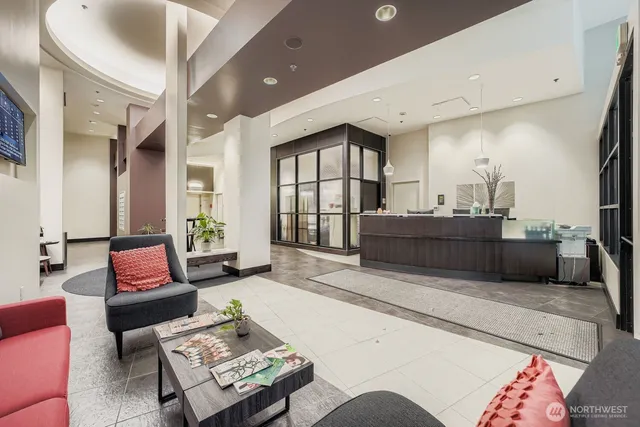 a living room with furniture and a potted plant