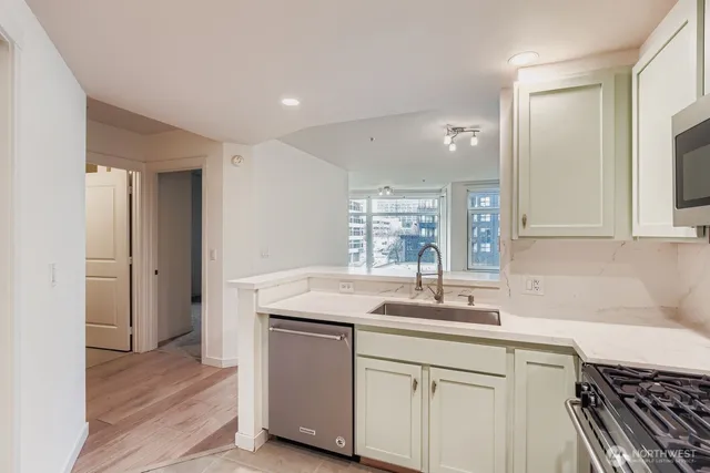 a kitchen with a sink cabinets and wooden floor
