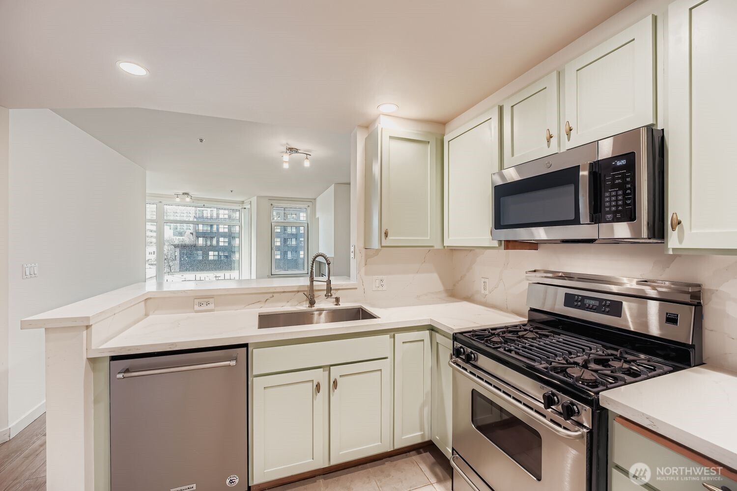 2607 Western Avenue, Unit 612 Seattle, WA 98121 - Photo 7 of 29 a kitchen with sink stove and microwave