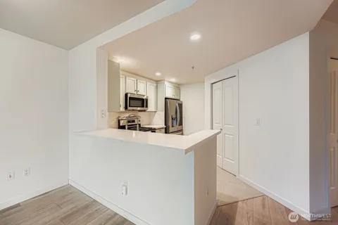 a view of kitchen with stainless steel appliances granite countertop refrigerator sink and stove