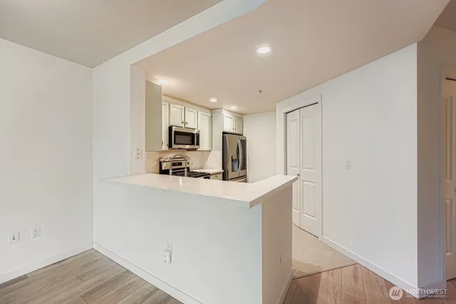 a view of kitchen with stainless steel appliances granite countertop refrigerator sink and stove