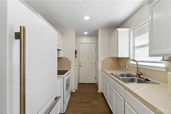 a kitchen with a sink and refrigerator