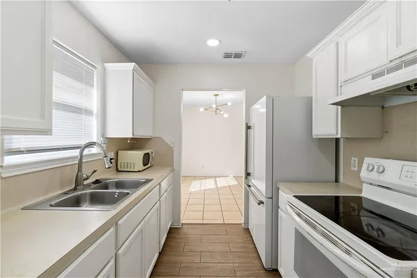 a kitchen with a sink stove and refrigerator