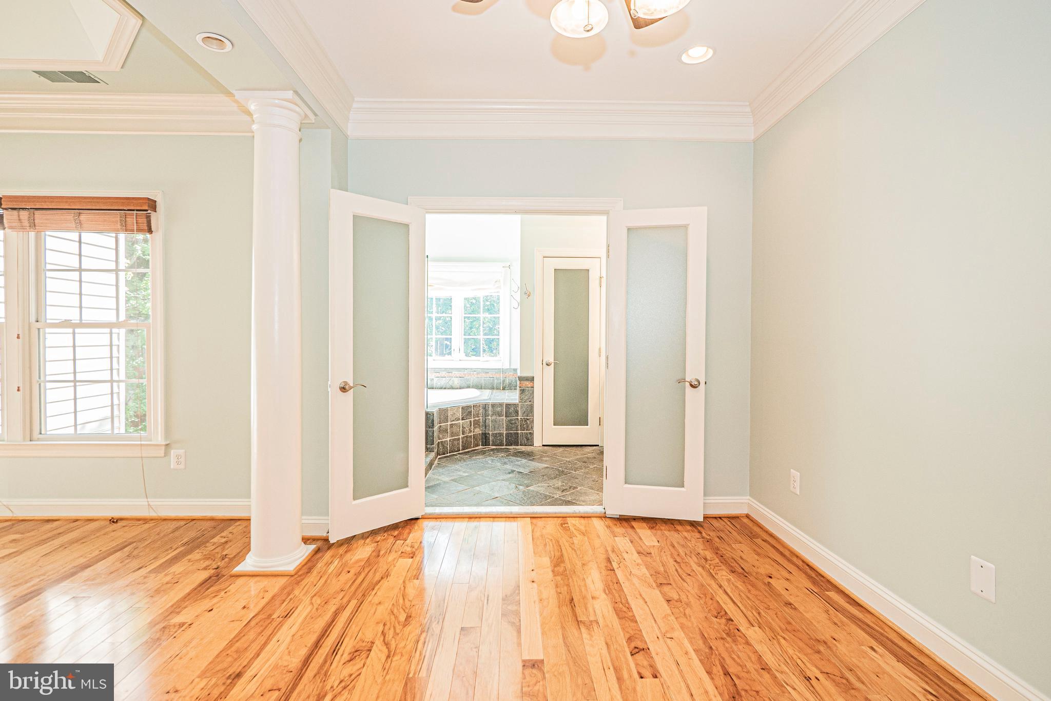 5448 Edsall Ridge Place Alexandria, VA 22312 - Photo 25 of 52 a view of a bedroom with wooden floor and bathroom
