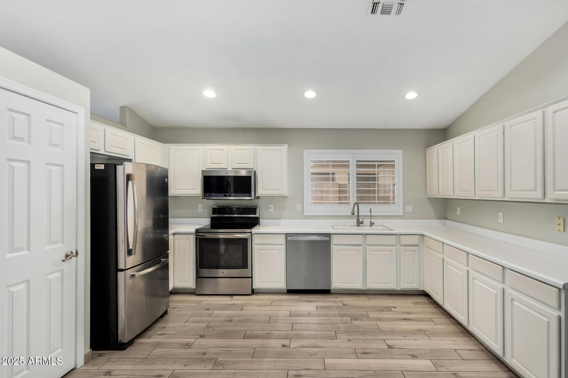 3942 East Agave Road Phoenix, AZ 85044 - Photo 11 of 30 a kitchen with stainless steel appliances granite countertop a refrigerator and a sink