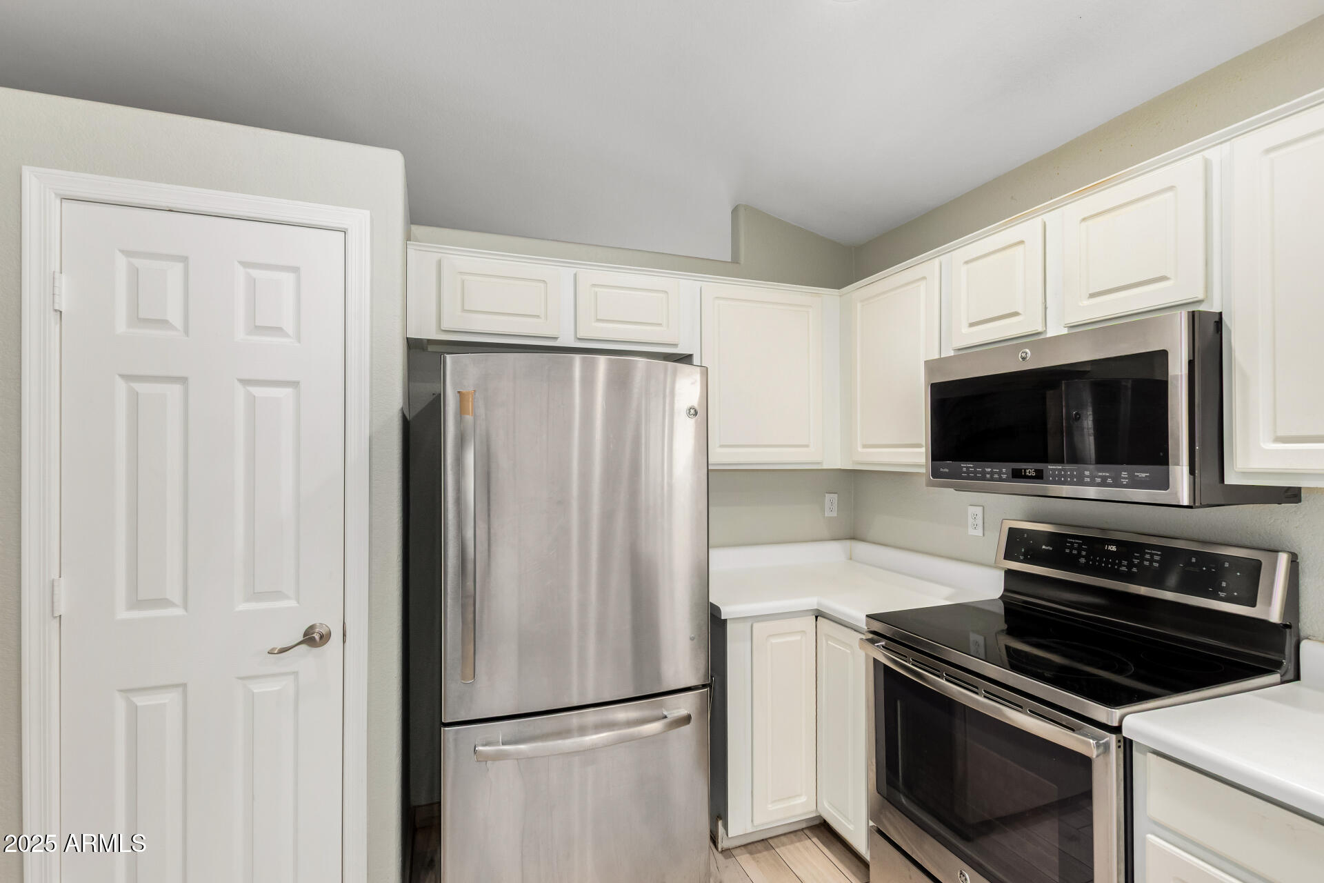 3942 East Agave Road Phoenix, AZ 85044 - Photo 14 of 30 a kitchen with a refrigerator stove and microwave