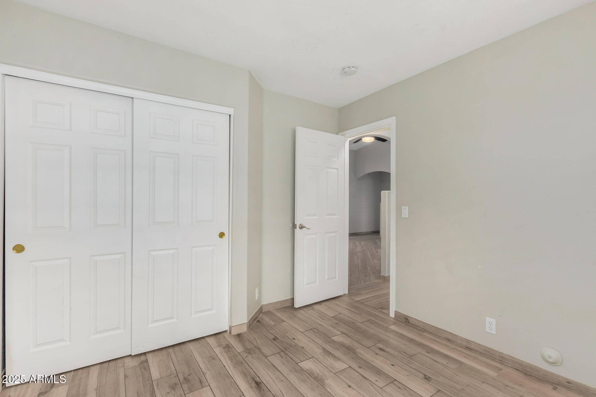 3942 East Agave Road Phoenix, AZ 85044 - Photo 20 of 30 a view of an empty room with wooden floor and closet