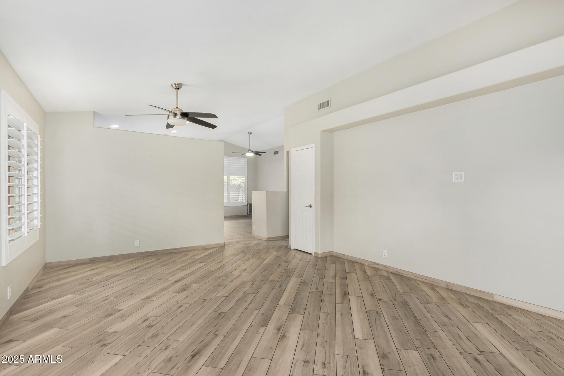 3942 East Agave Road Phoenix, AZ 85044 - Photo 6 of 30 wooden floor in an empty room with a window