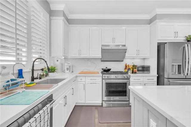 a kitchen with cabinets a sink and appliances