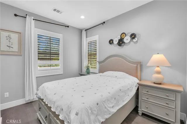 a bedroom with a bed and a painting on the wall