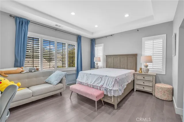 a spacious bedroom with a bed and a couch