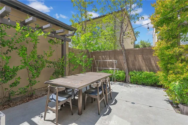 a view of a patio with table and chairs with wooden floor and plants