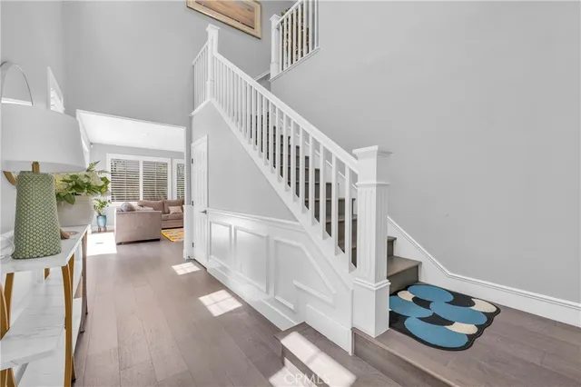 a view of entryway and hall with wooden floor