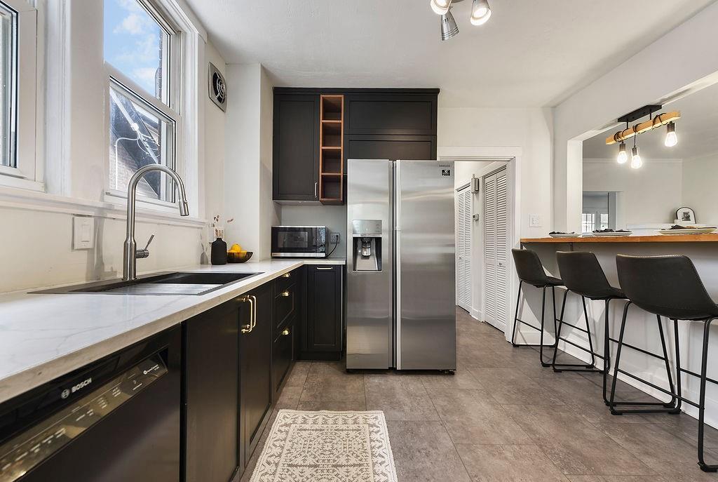 6418 Landview Road Pittsburgh, PA 15217 - Photo 13 of 40 a kitchen with stainless steel appliances a refrigerator a sink a stove and chairs