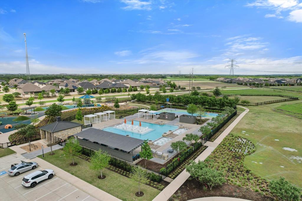 6910 Prairieside Trail Venus, TX 76084 - Photo 39 of 40 An aerial view of the community, highlighting the swimming pool with shaded lounge areas, a playground, and open green spaces