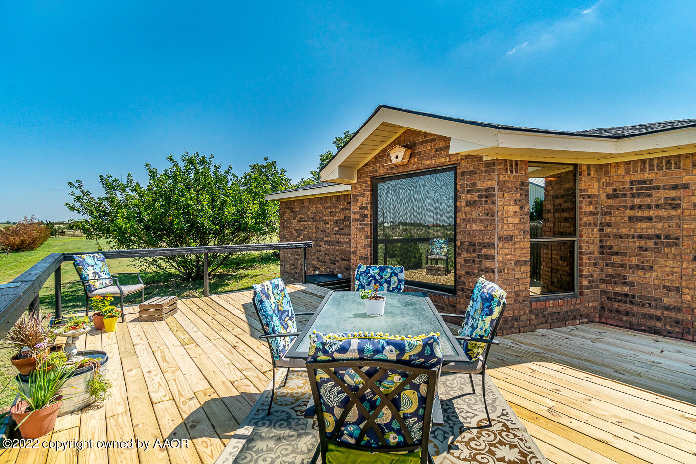 a view of a patio with table and chairs and potted plants