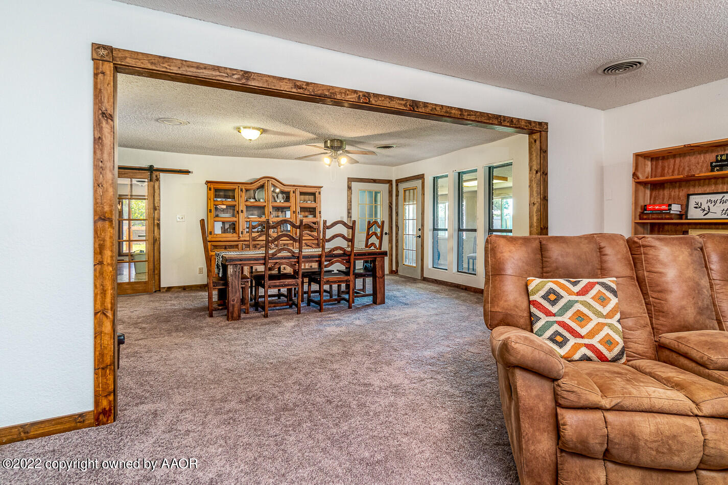 8780 County Line Road Fritch, TX 79036 - Photo 11 of 48 a living room with furniture and a dining table with projector the kitchen