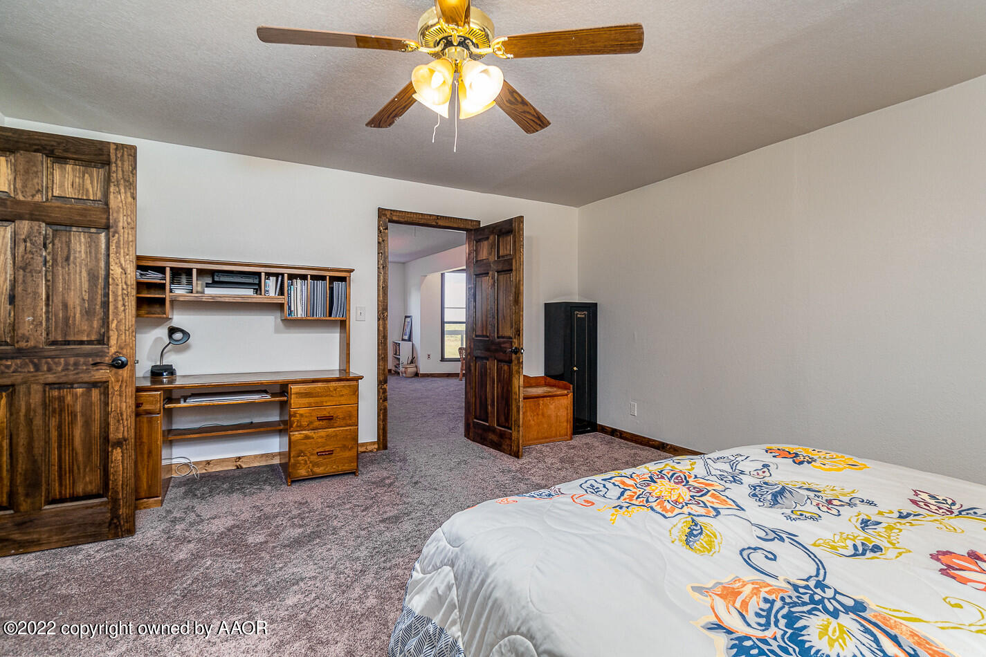 8780 County Line Road Fritch, TX 79036 - Photo 16 of 48 a bedroom with a bed and a chandelier