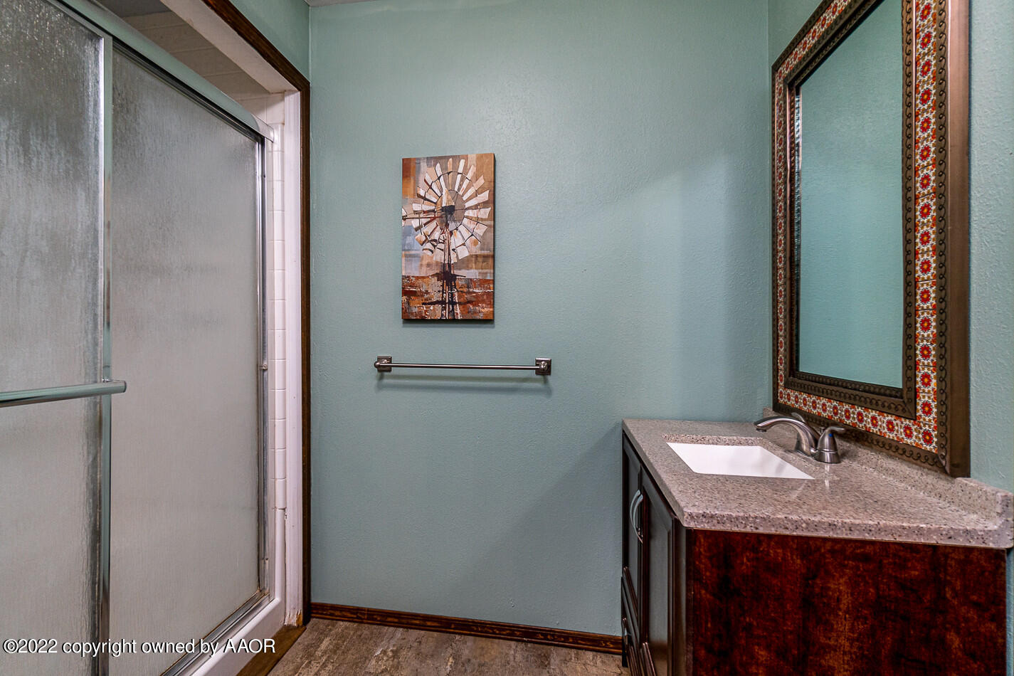 8780 County Line Road Fritch, TX 79036 - Photo 17 of 48 a bathroom with a granite countertop sink and a mirror