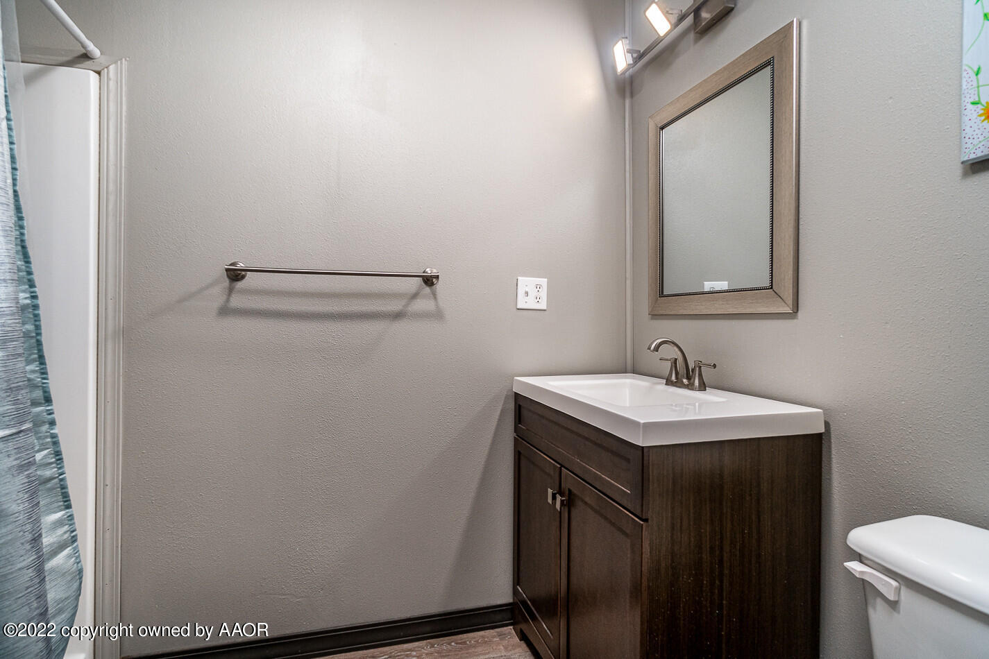8780 County Line Road Fritch, TX 79036 - Photo 20 of 48 a bathroom with a sink a toilet and mirror