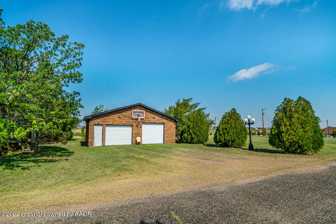 8780 County Line Road Fritch, TX 79036 - Photo 3 of 48 a front view of a house with a yard and garage
