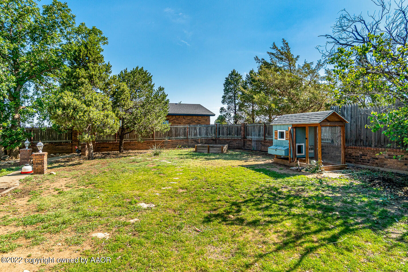 8780 County Line Road Fritch, TX 79036 - Photo 32 of 48 a view of house with swimming pool outdoor seating and trees in the background