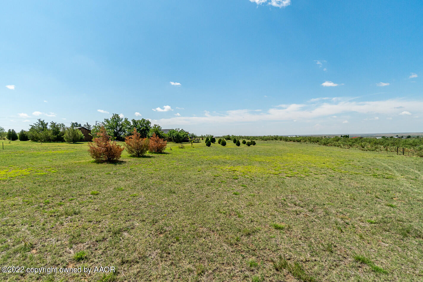 8780 County Line Road Fritch, TX 79036 - Photo 45 of 48 a backyard of a house with lots of green space and lake view