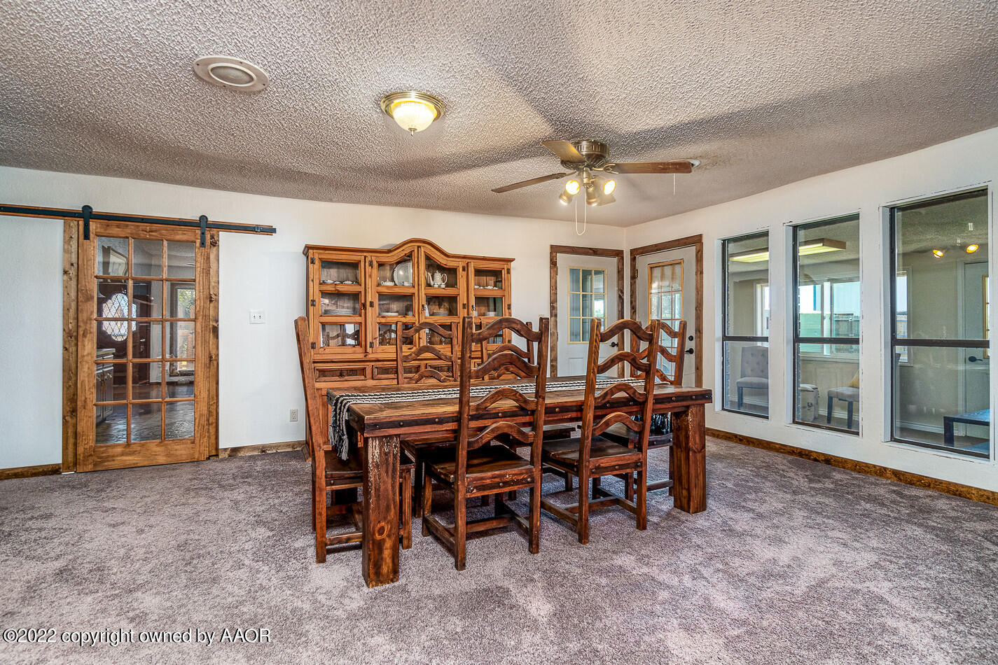 8780 County Line Road Fritch, TX 79036 - Photo 10 of 48 a view of a dining room with furniture and a floor to ceiling window