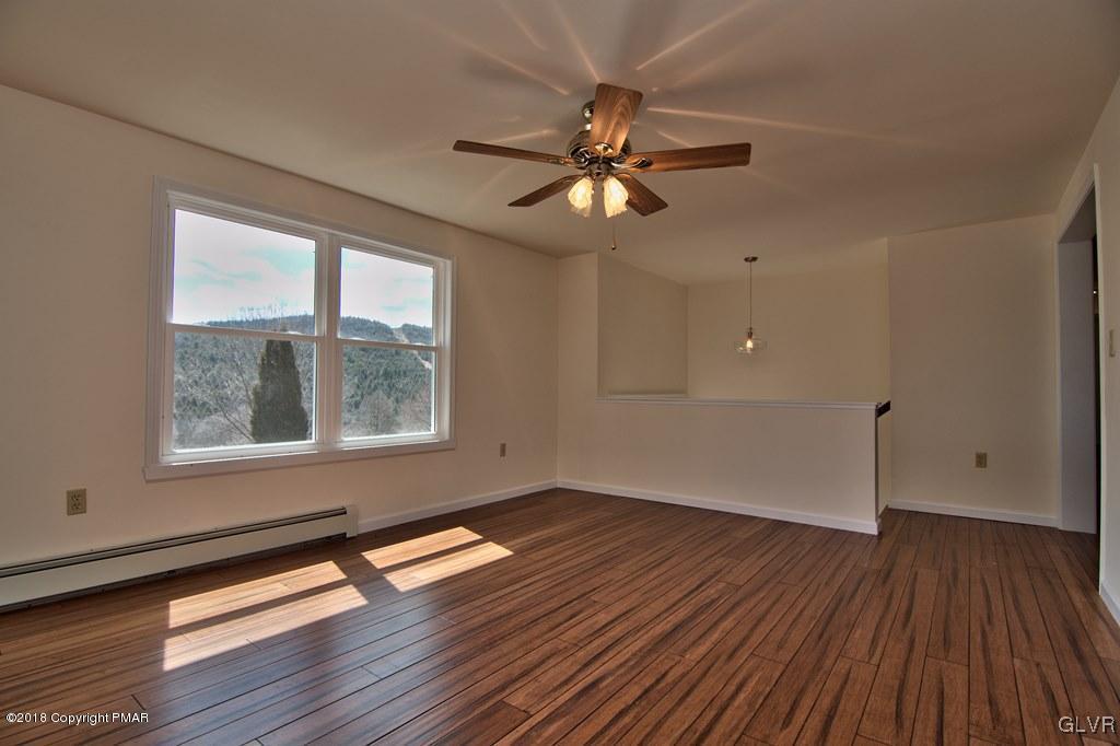 335 Kunkletown Road Kunkletown, PA 18058 - Photo 14 of 44 a view of empty room with wooden floor and fan