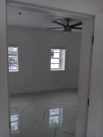 a view of an empty room and a window