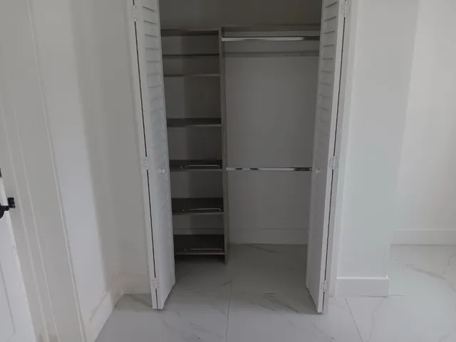 a bathroom with a shower a toilet and sink