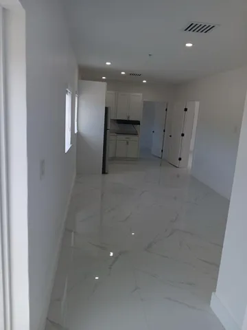 an empty room with a kitchen