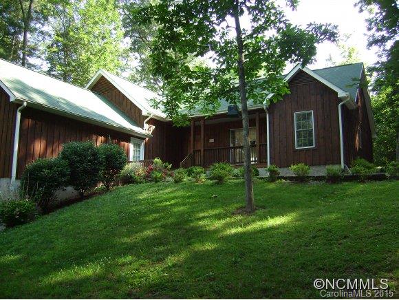 164 Thistle Ridge Clyde, NC 28721 - Photo 1 of 16 a house with green field in front of it