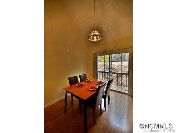 164 Thistle Ridge Clyde, NC 28721 - Photo 4 of 16 a view of a dining room with furniture and wooden floor