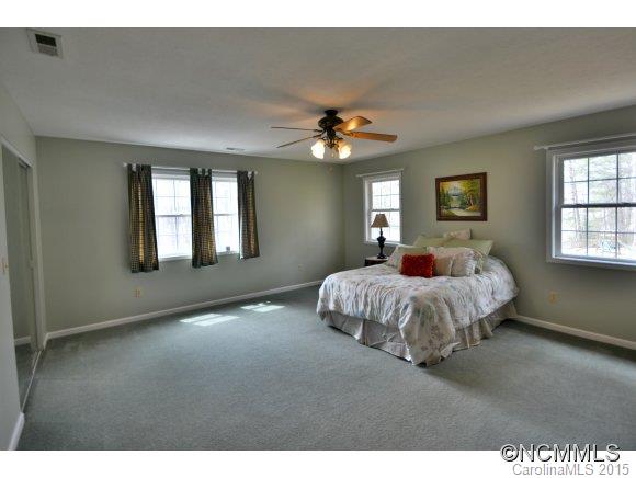 164 Thistle Ridge Clyde, NC 28721 - Photo 8 of 16 a bedroom with a bed ceiling fan and window